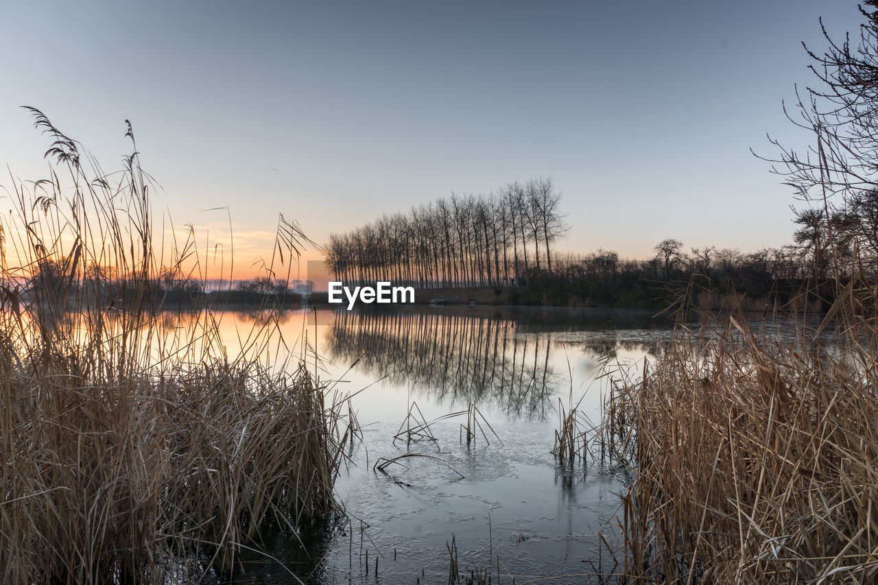 LAKE AGAINST CLEAR SKY DURING WINTER