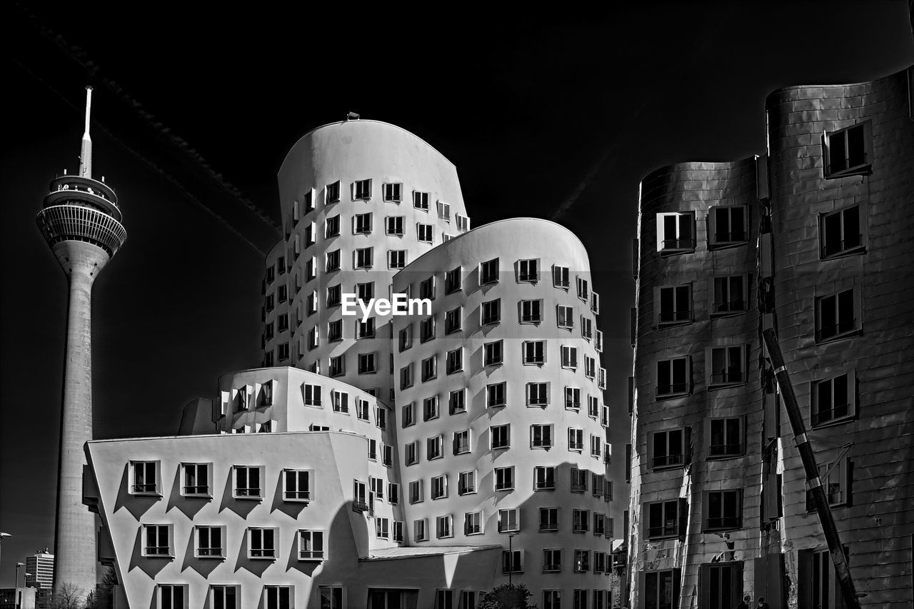 Low angle view of buildings in city at night