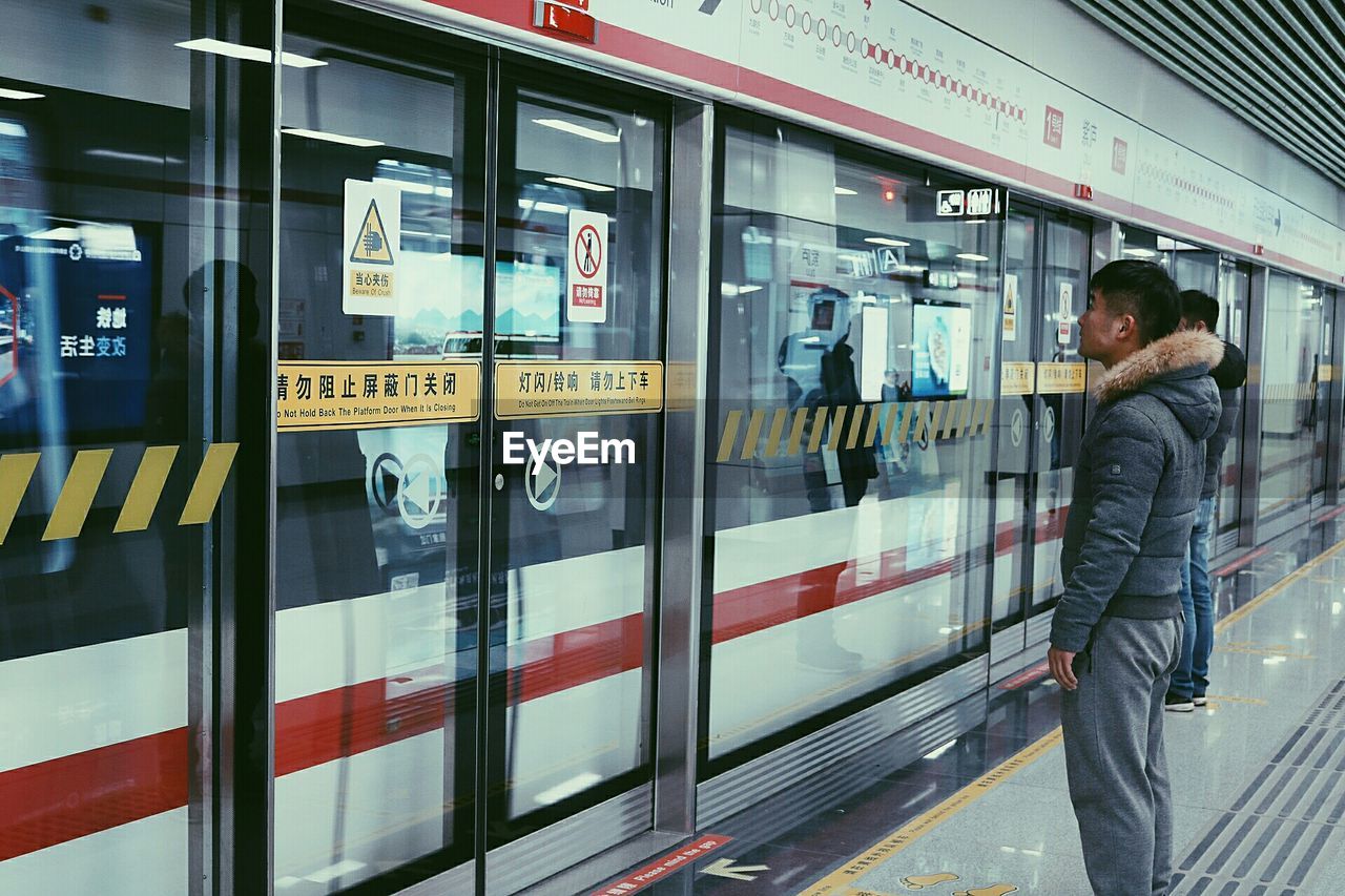 REFLECTION OF MAN IN BUS ON MIRROR