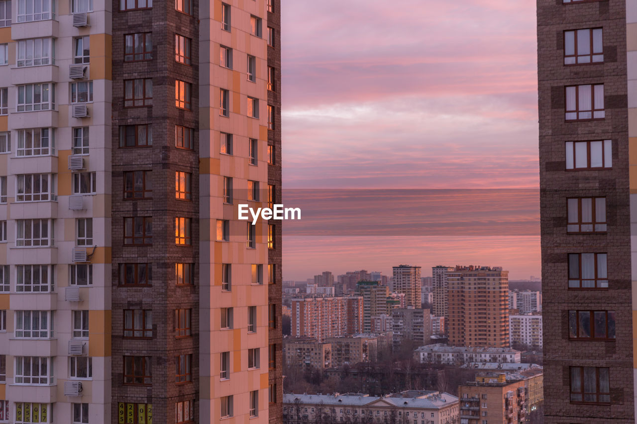 Buildings in city at sunset