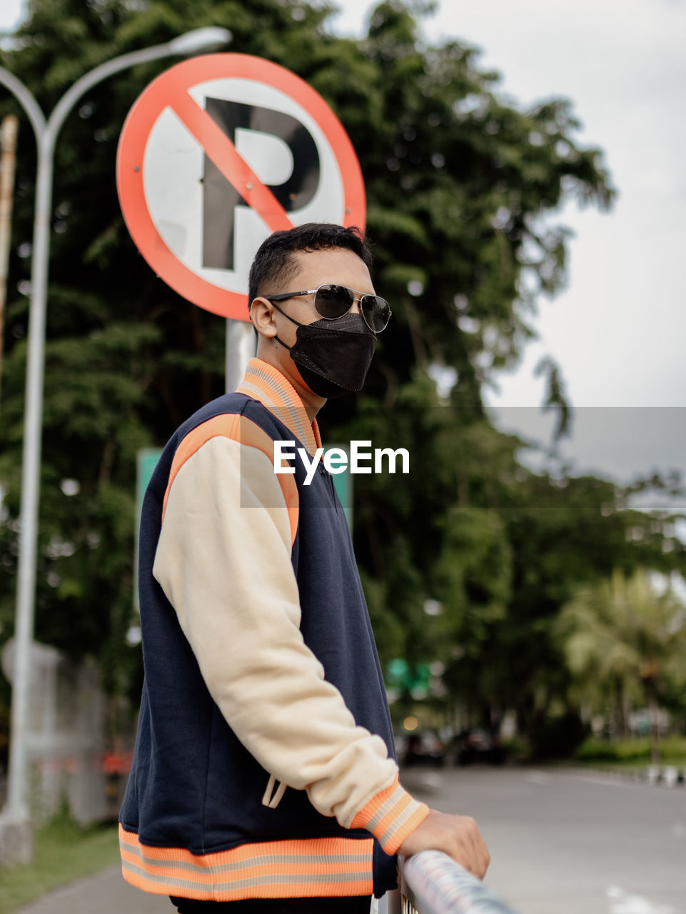 Young man wearing mask standing outdoors