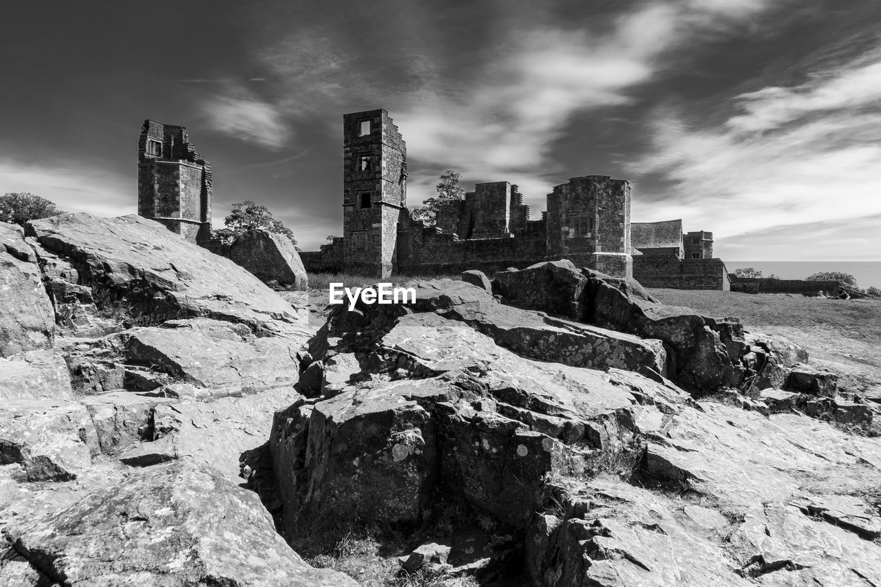 LOW ANGLE VIEW OF DAMAGED BUILDING AGAINST SKY