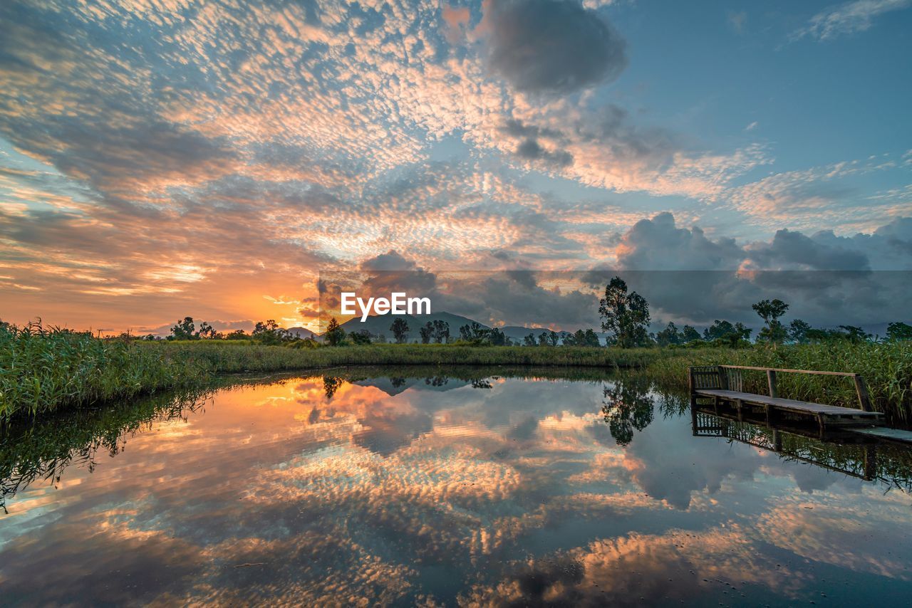 Scenic view of morning sunrise against sky in wetland pool / lake, hong kong