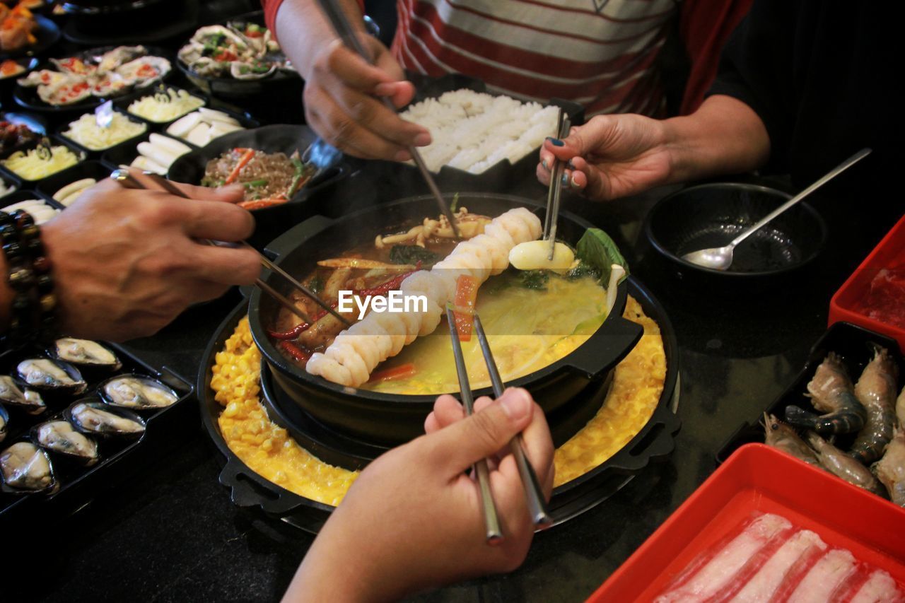 Cropped hand of woman preparing food