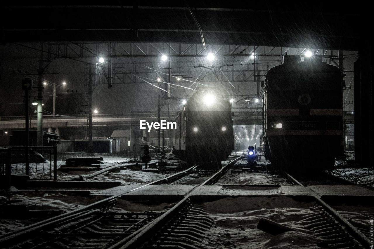 ILLUMINATED RAILROAD TRACK AT NIGHT