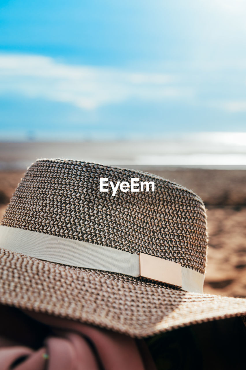 CLOSE-UP OF HAT ON SAND