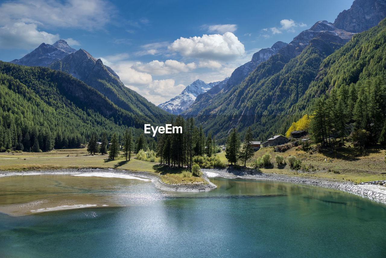 Scenic view of lake and mountains against sky