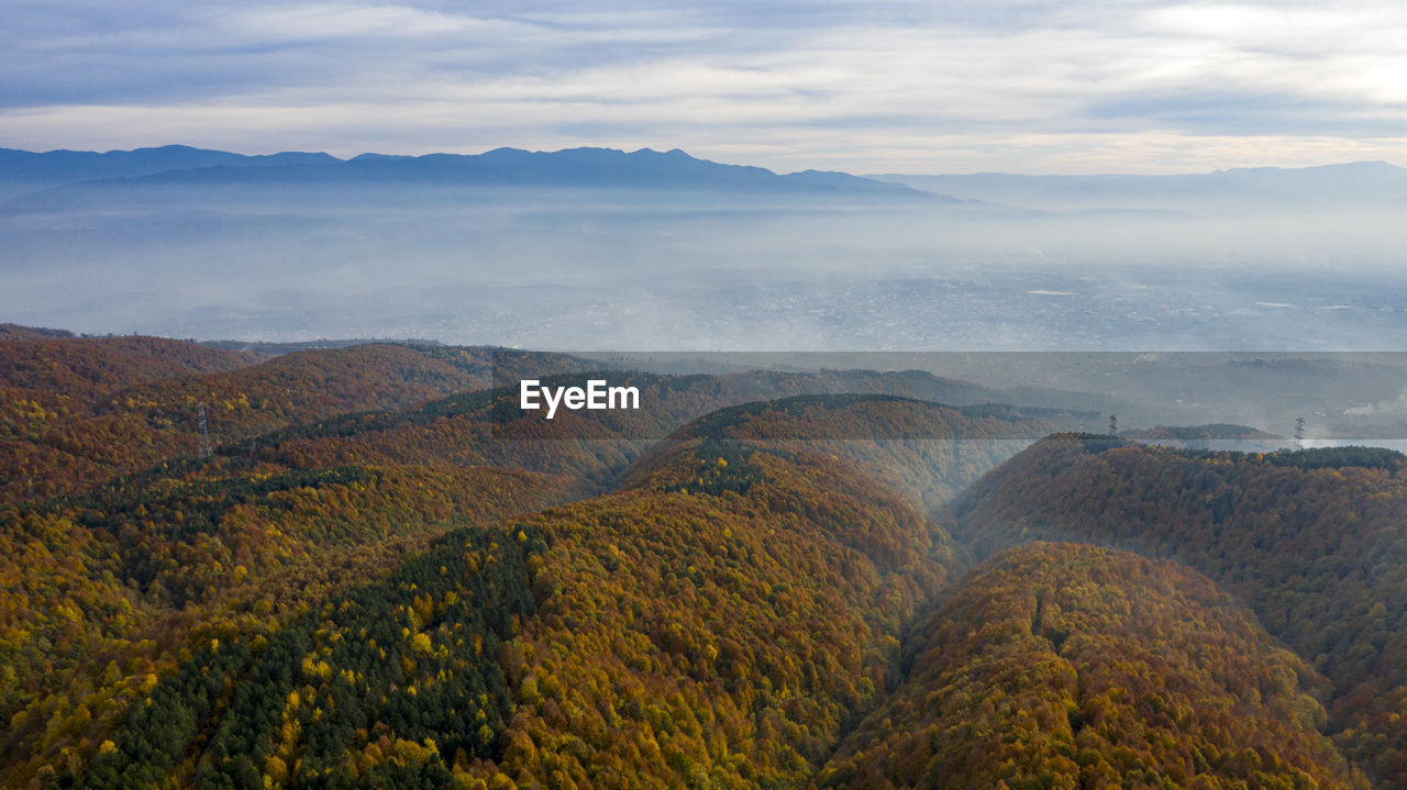 SCENIC VIEW OF LAND AND MOUNTAINS AGAINST SKY