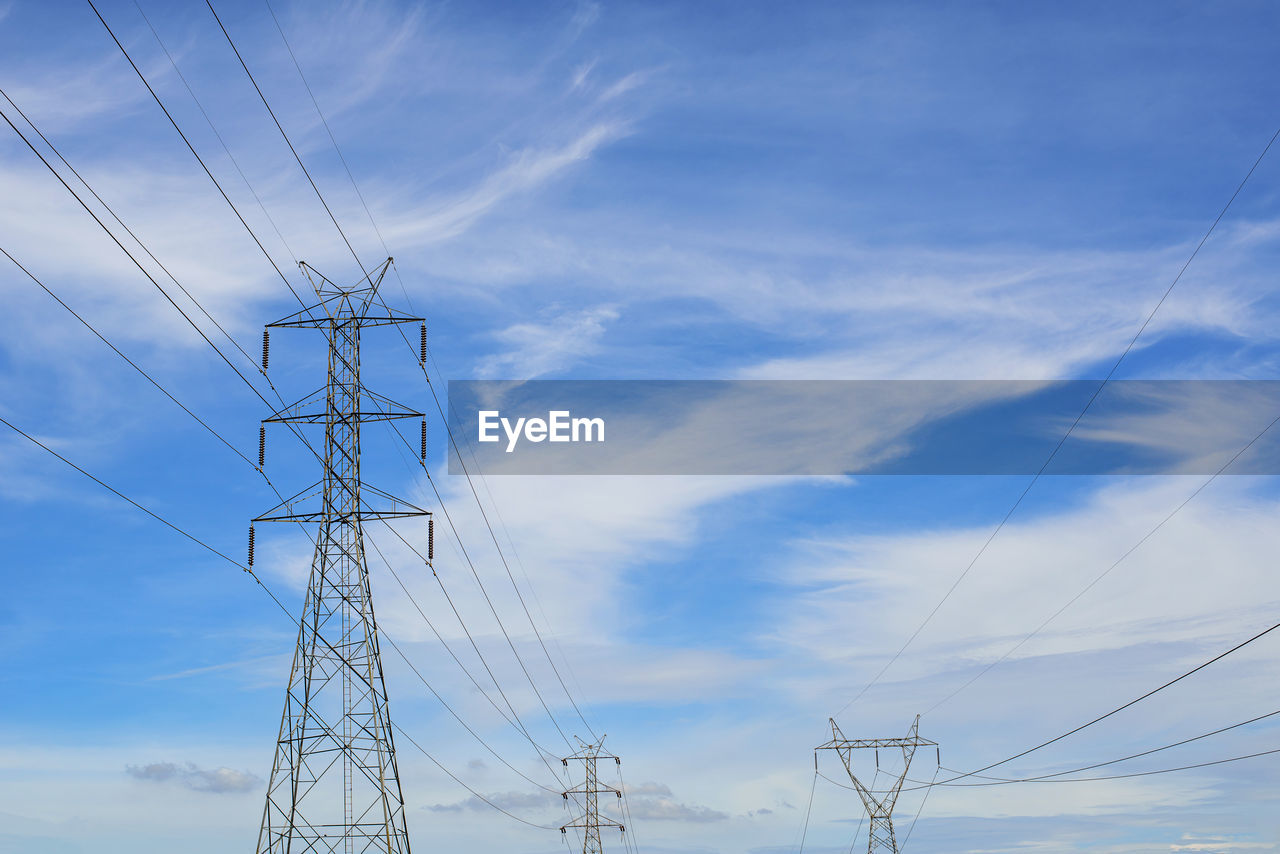 High voltage power transmission tower and sky background