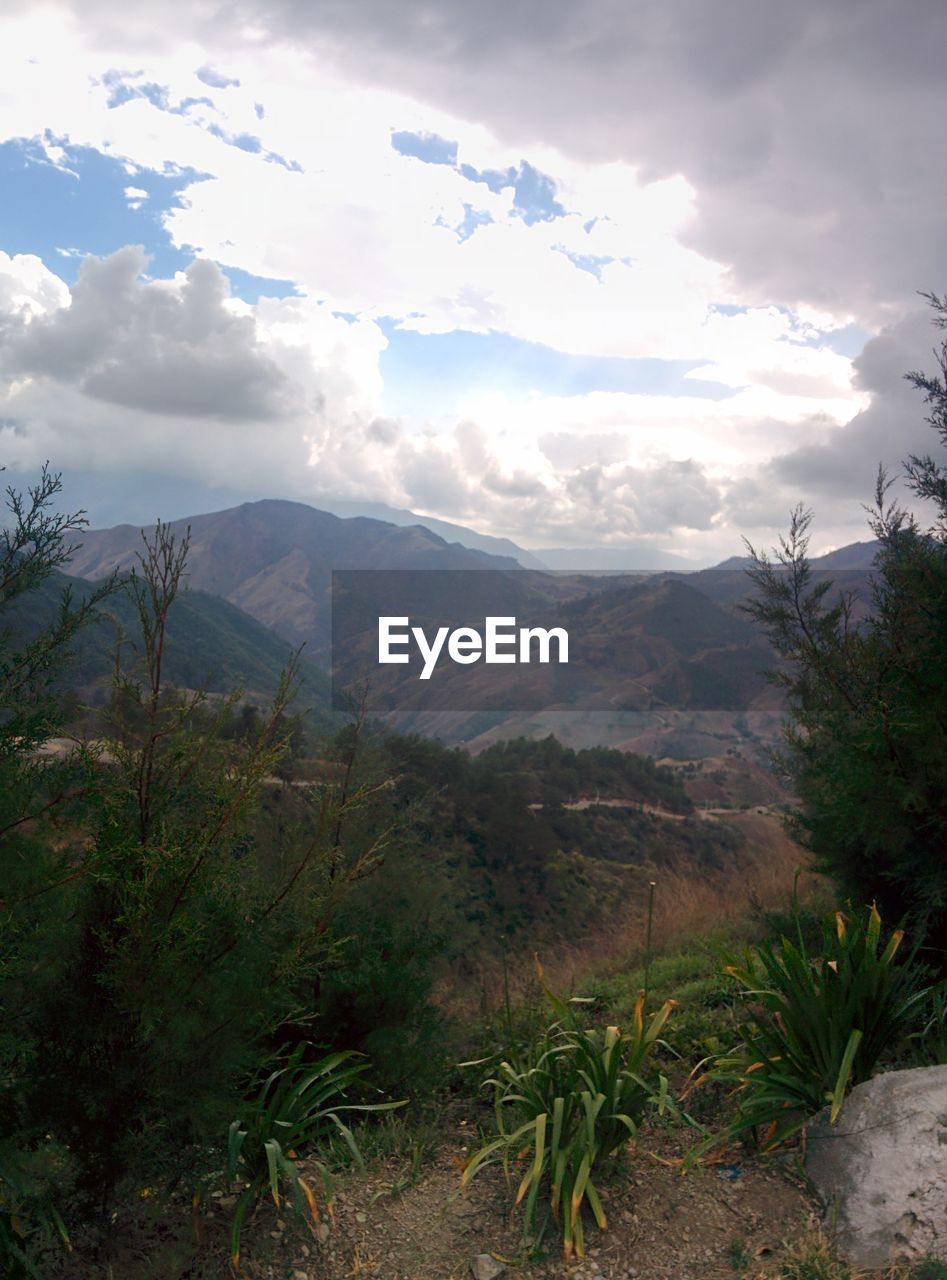 SCENIC VIEW OF LANDSCAPE AND MOUNTAINS AGAINST SKY