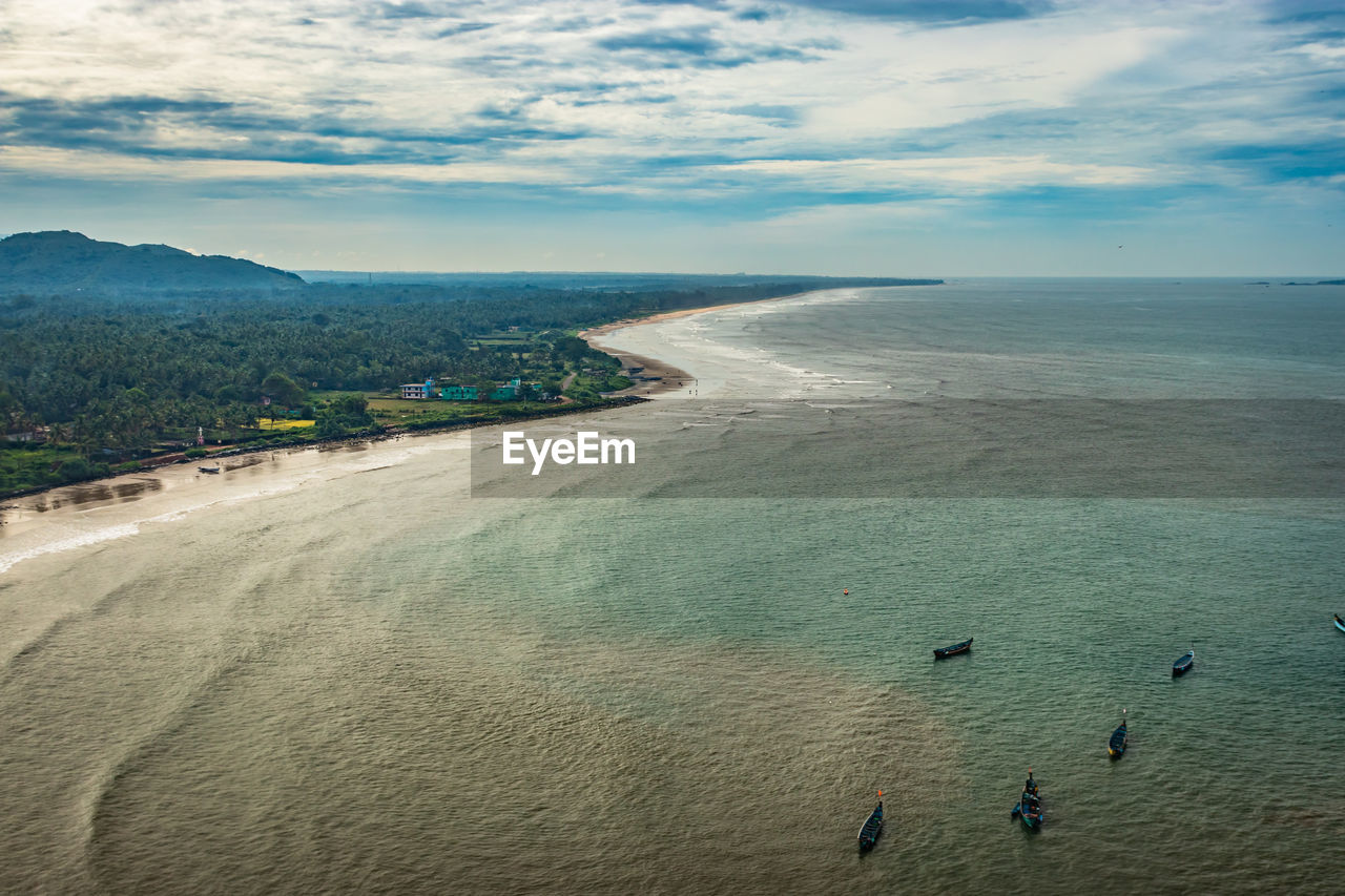 Beach isolated with fishing boats aerial shots with dramatic sky