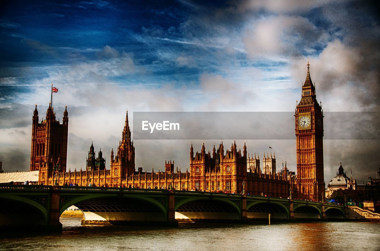 Westminster bridge over thames river against sky in city