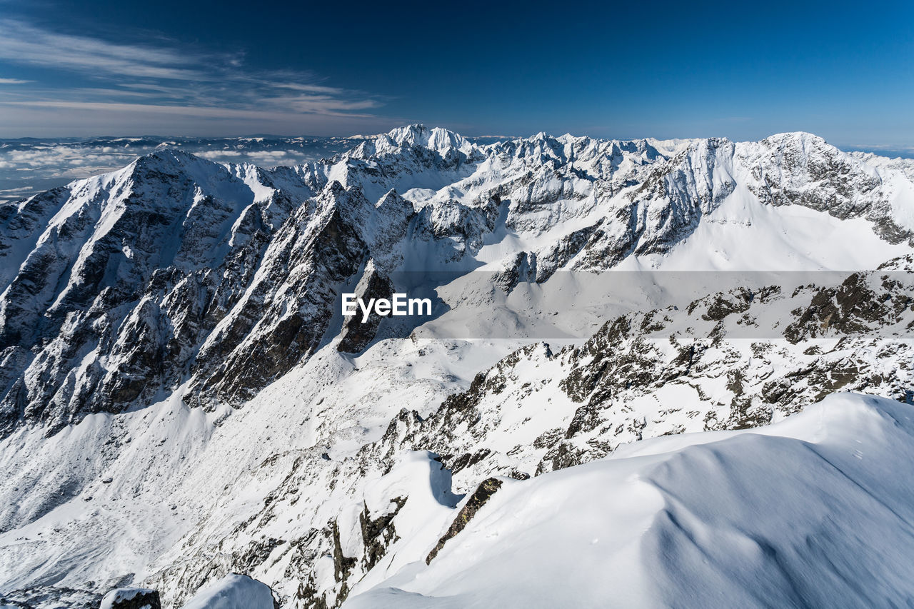 Scenic view of snowcapped mountains against sky. view from lomnica, tatra mountains, poland