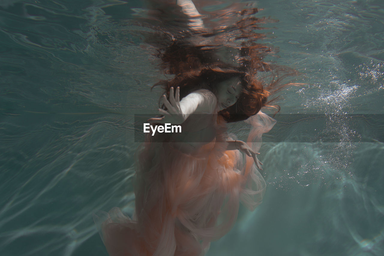 Woman swimming in swimming pool