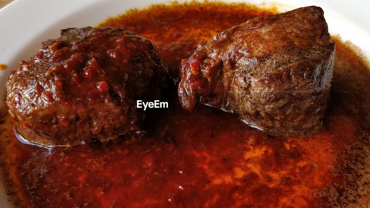 CLOSE-UP OF ROASTED MEAT ON BARBECUE GRILL