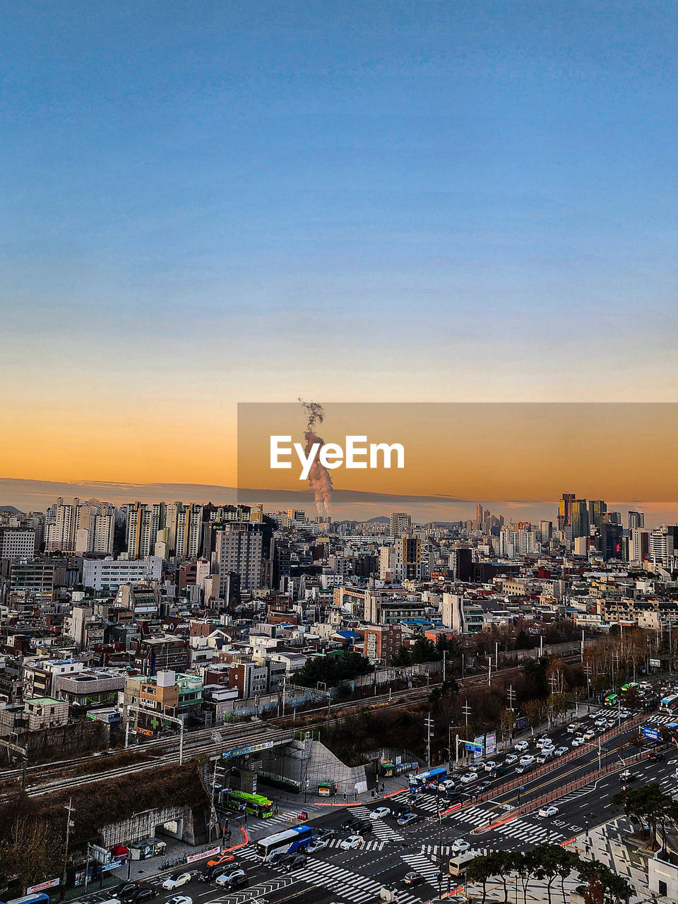 High angle view of illuminated cityscape against sky during sunrise. 