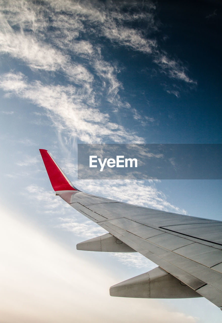 Close-up of airplane wing against sky