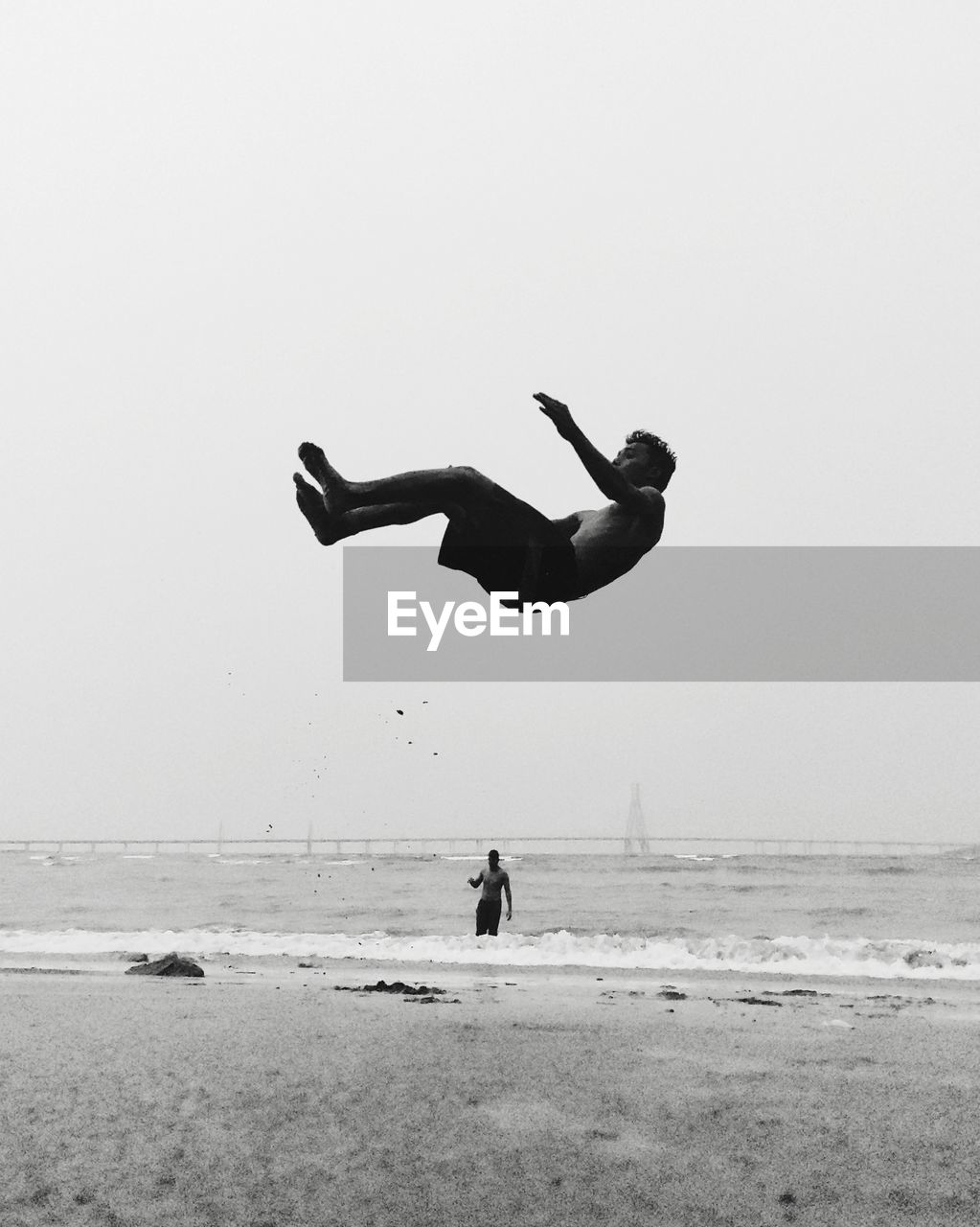 MAN ON BEACH AGAINST SKY