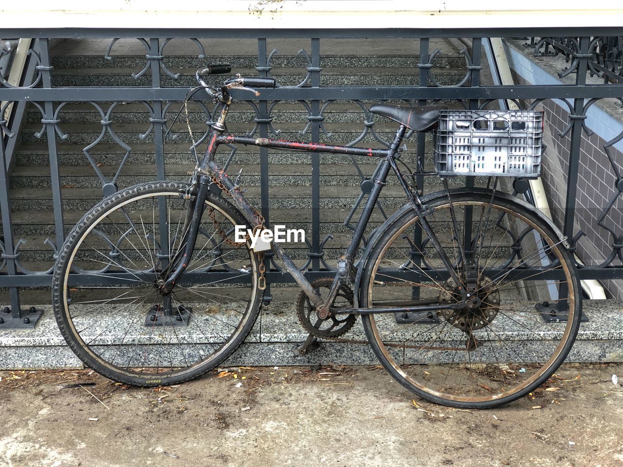 BICYCLES PARKED BY RAILING