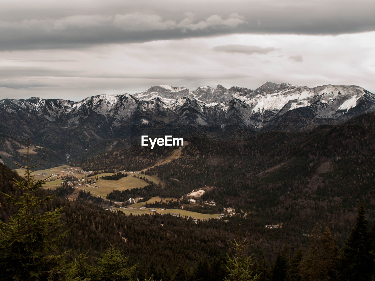 Scenic view of mountains against cloudy sky