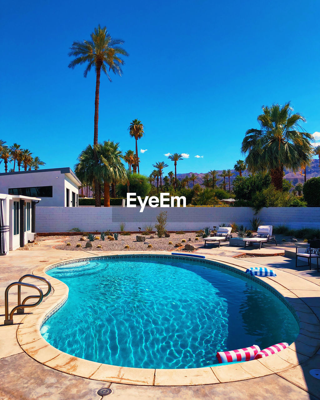 SWIMMING POOL AGAINST BLUE SKY