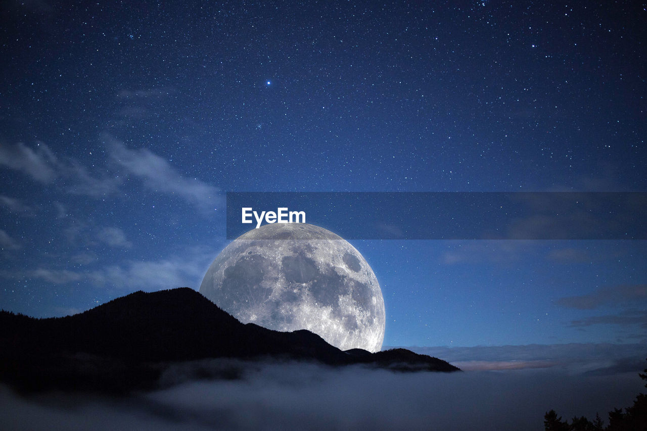 Low angle view of moon against sky at night