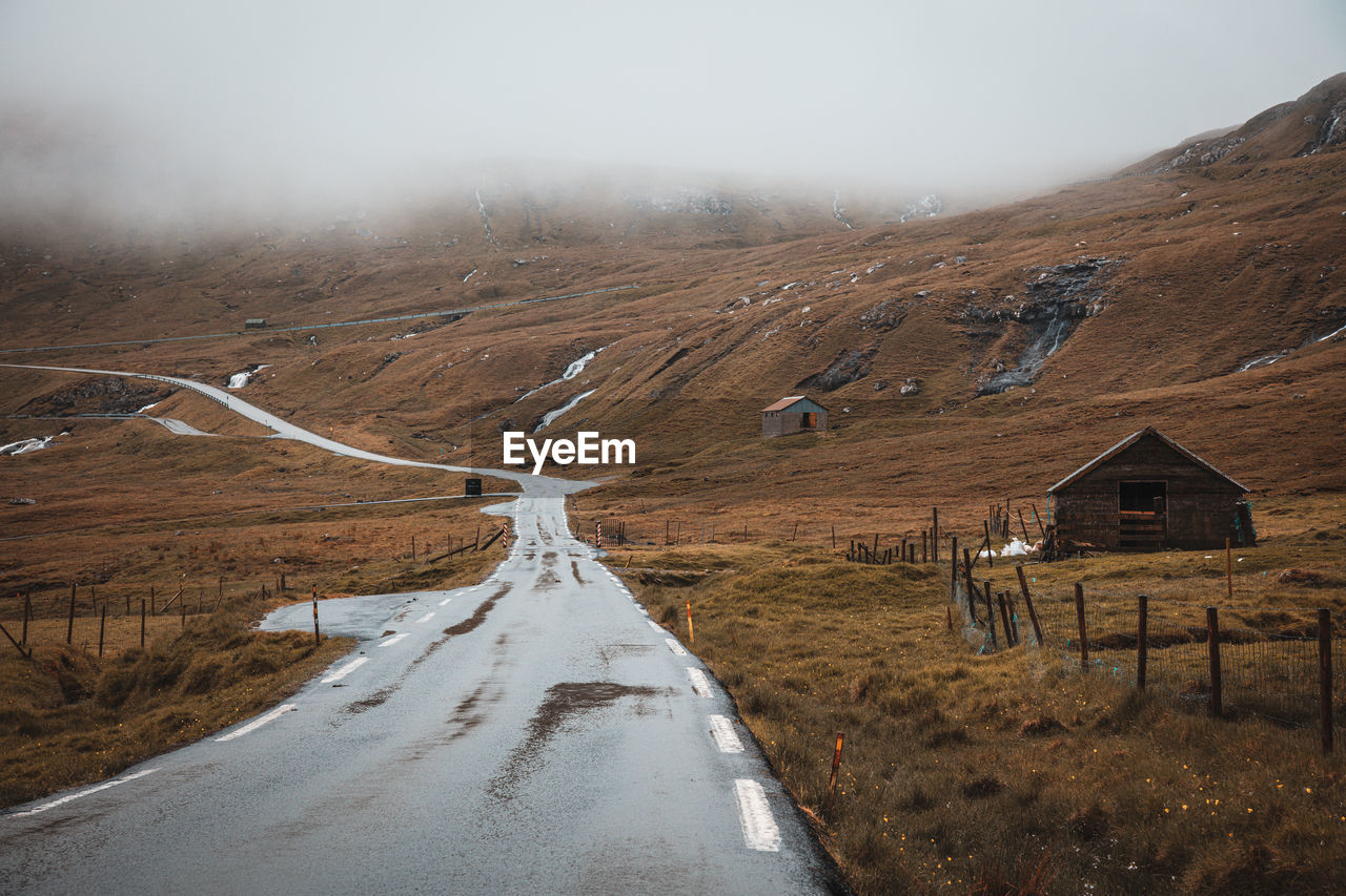 Empty road leading towards mountain