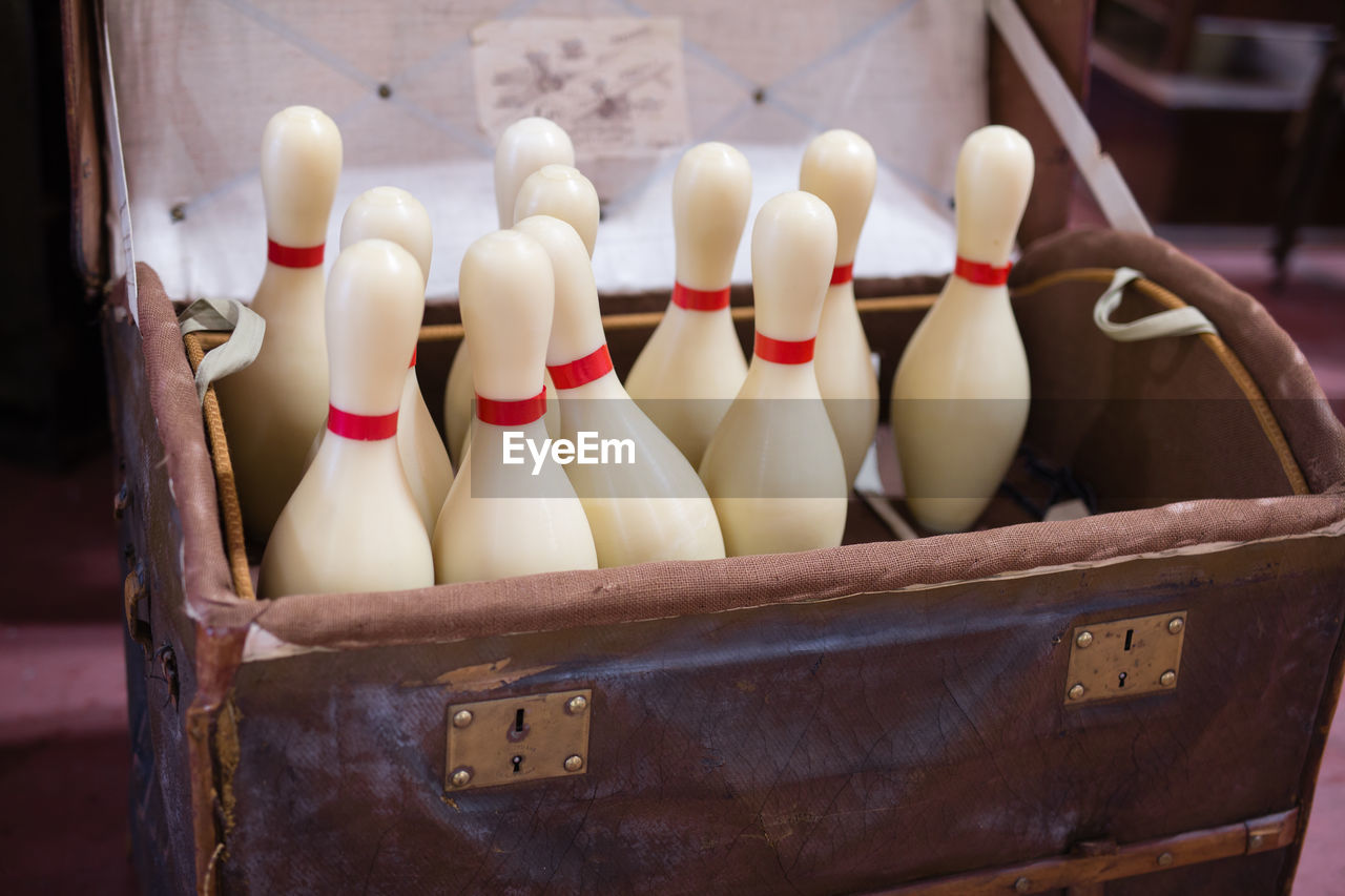 Close-up of bowling pins in container