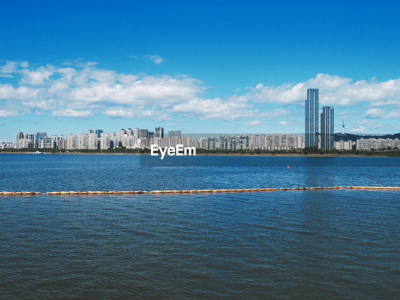 Scenic view of sea and buildings against sky