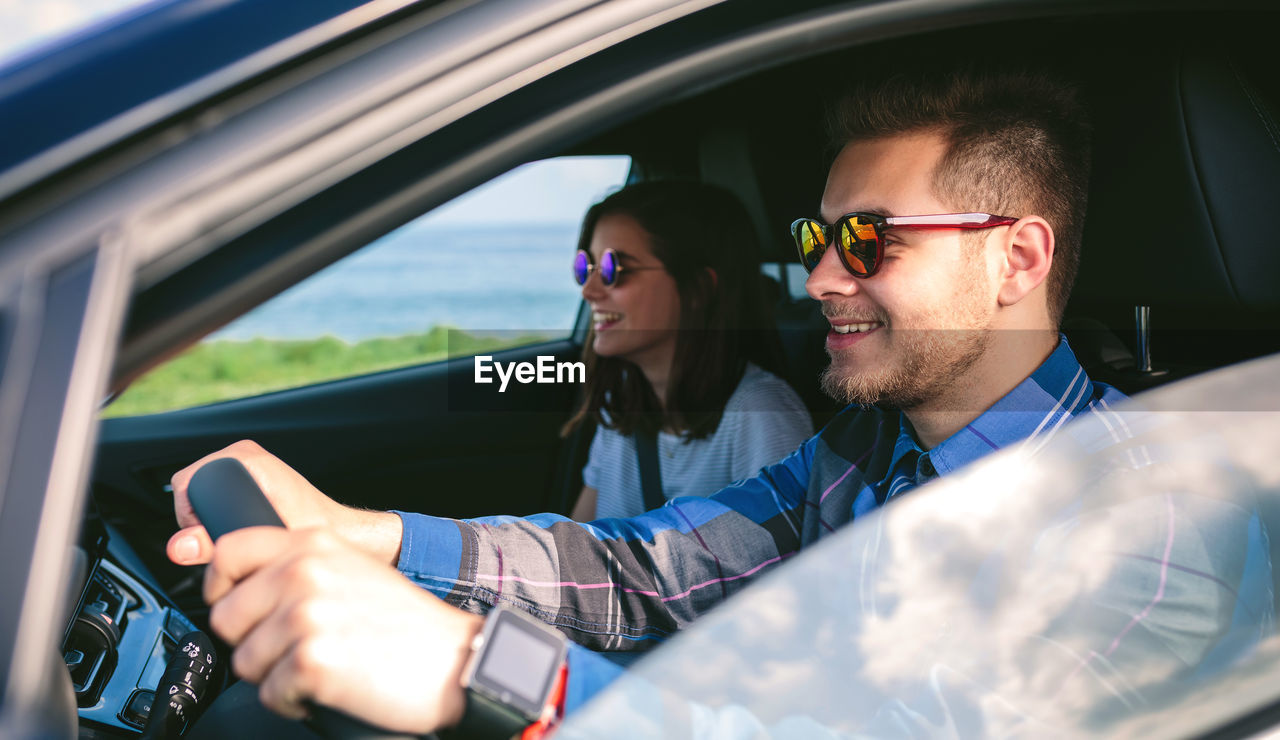 Young couple driving car