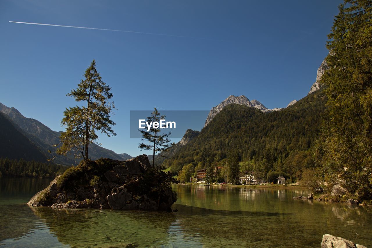 Scenic view of lake and mountains against clear sky