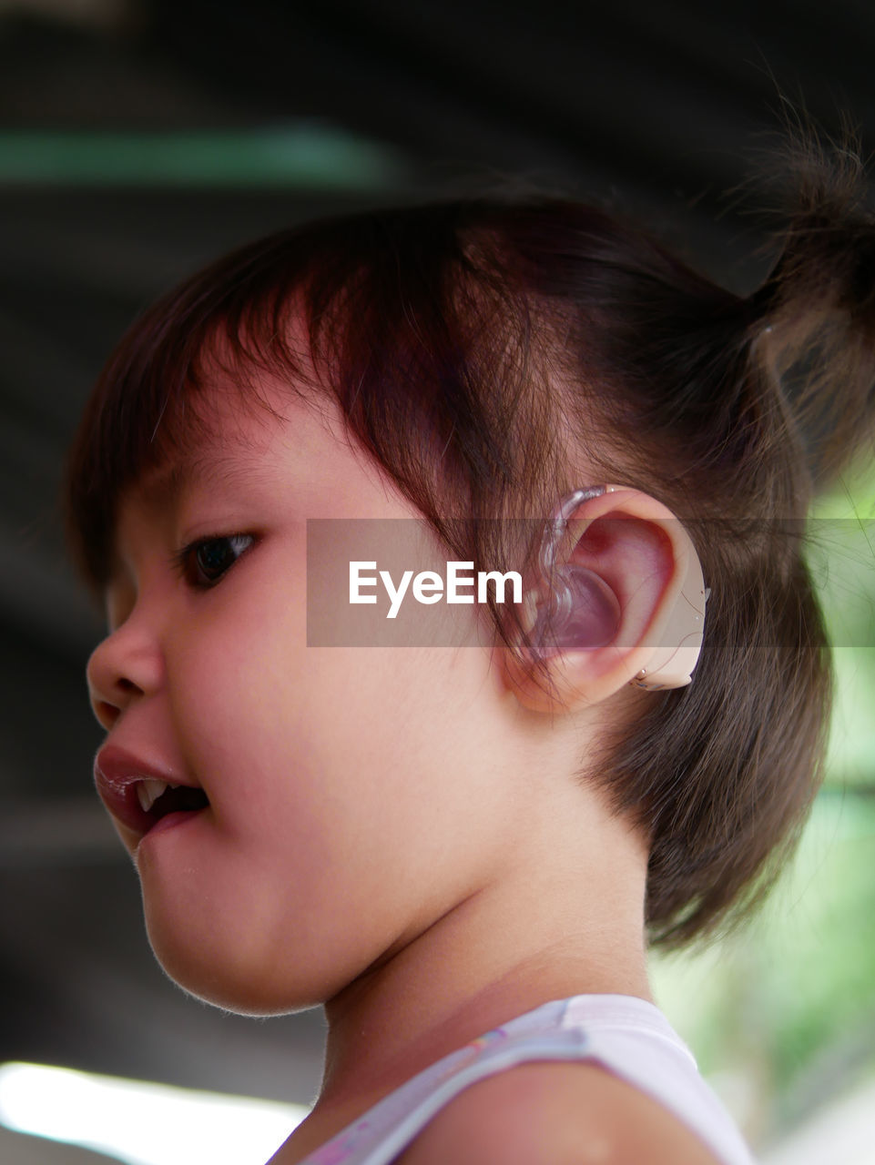 Close-up of cute girl wearing hearing aid