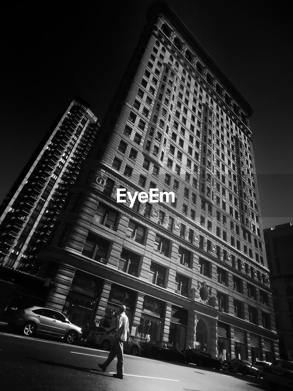 LOW ANGLE VIEW OF MODERN OFFICE BUILDING AGAINST SKY AT NIGHT