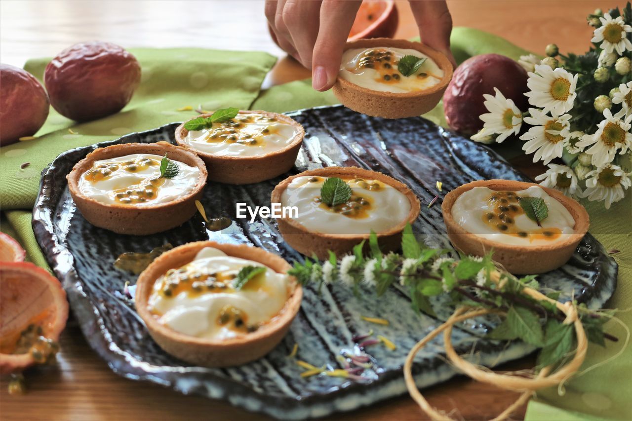 High angle view of person taking sweet food on table