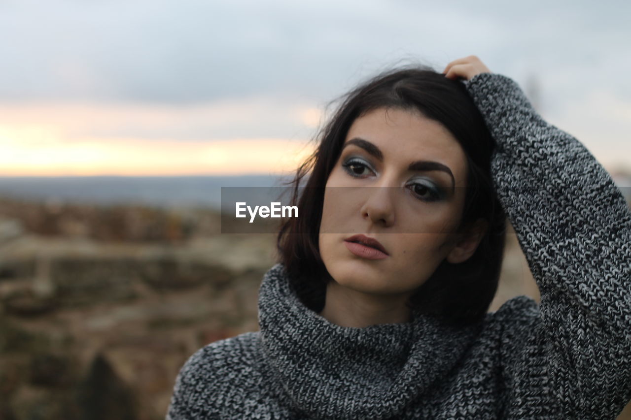 Close-up of thoughtful woman wearing warm clothing during winter