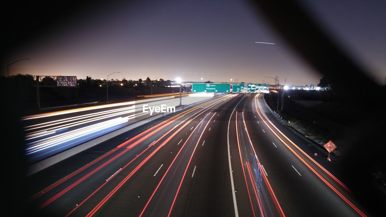 LIGHT TRAILS ON ROAD IN CITY