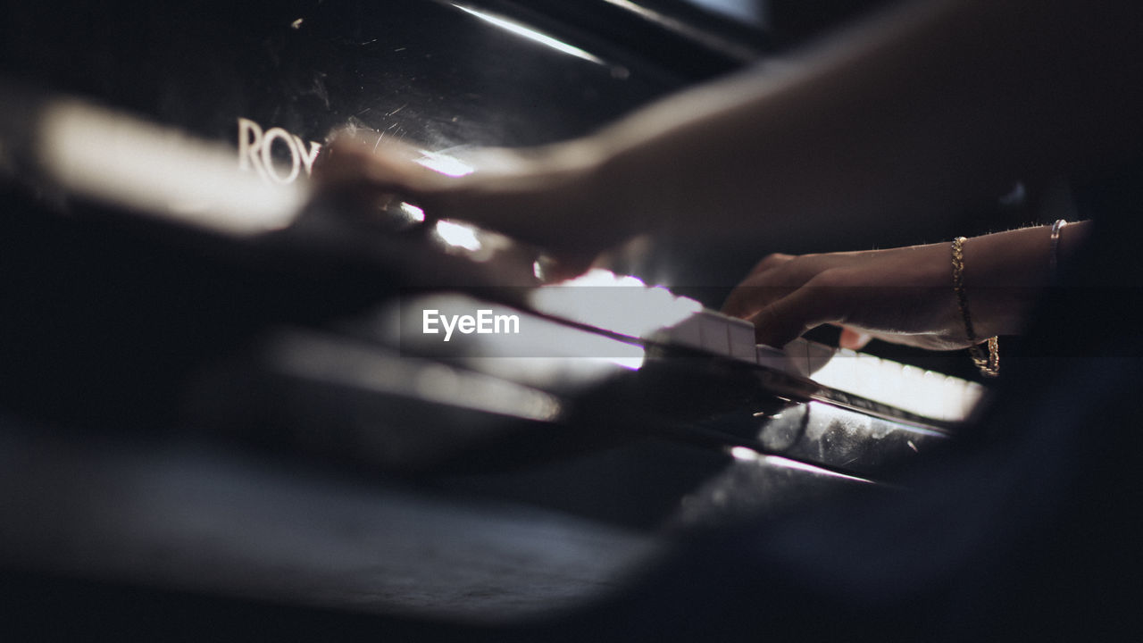 Cropped image of woman playing piano