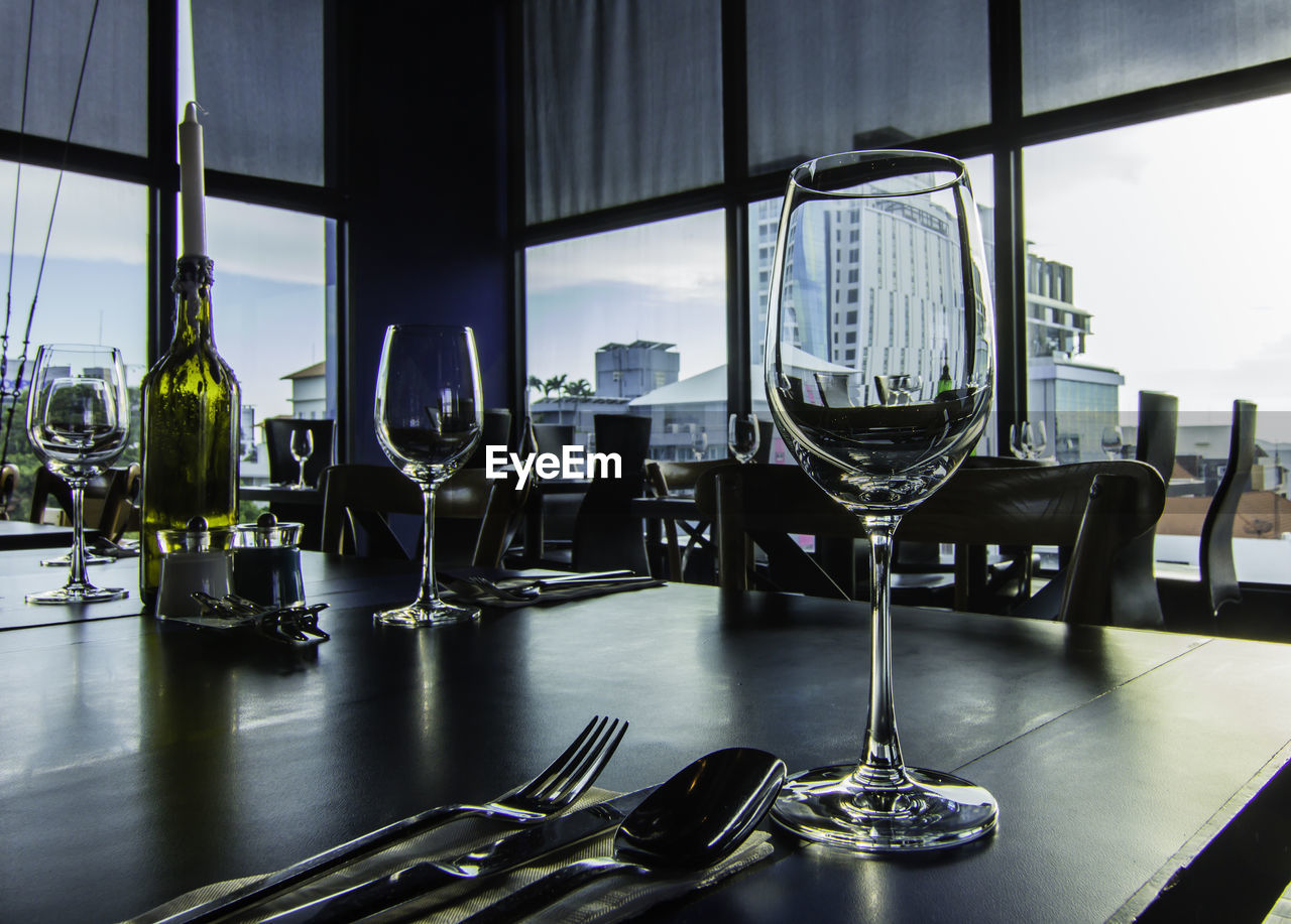 CHAIRS AND TABLES IN GLASS WINDOW