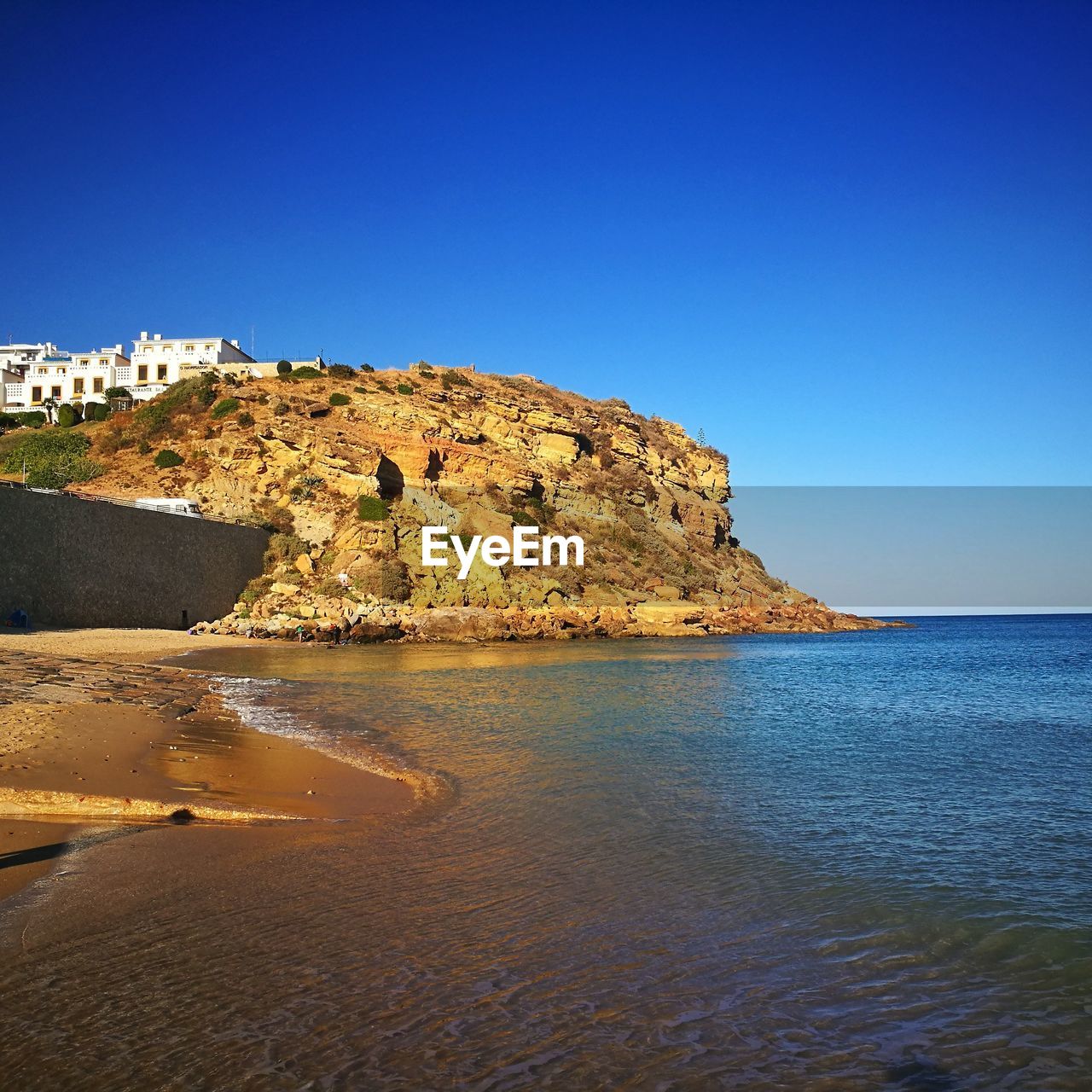 Scenic view of sea against clear blue sky