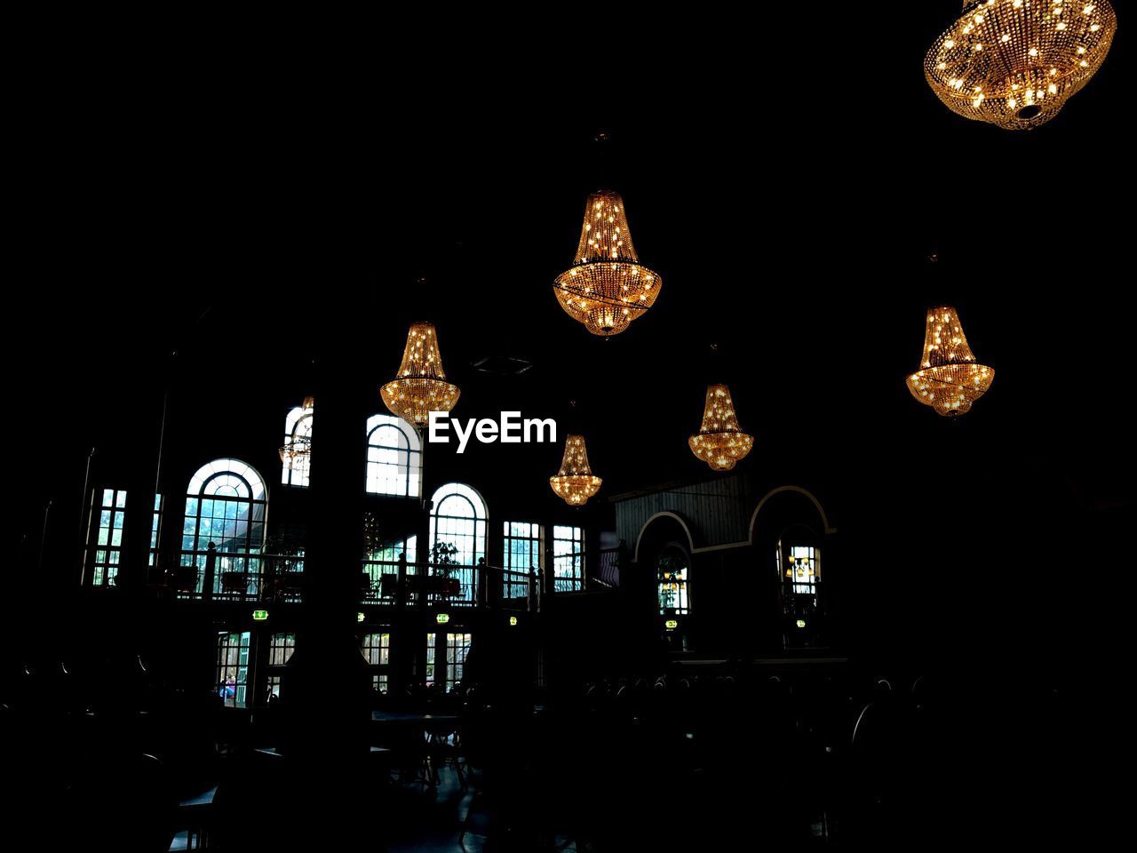 LOW ANGLE VIEW OF ILLUMINATED LIGHT AGAINST BLACK BACKGROUND