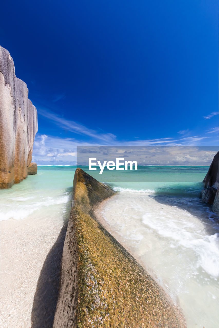 Scenic view of beach against blue sky