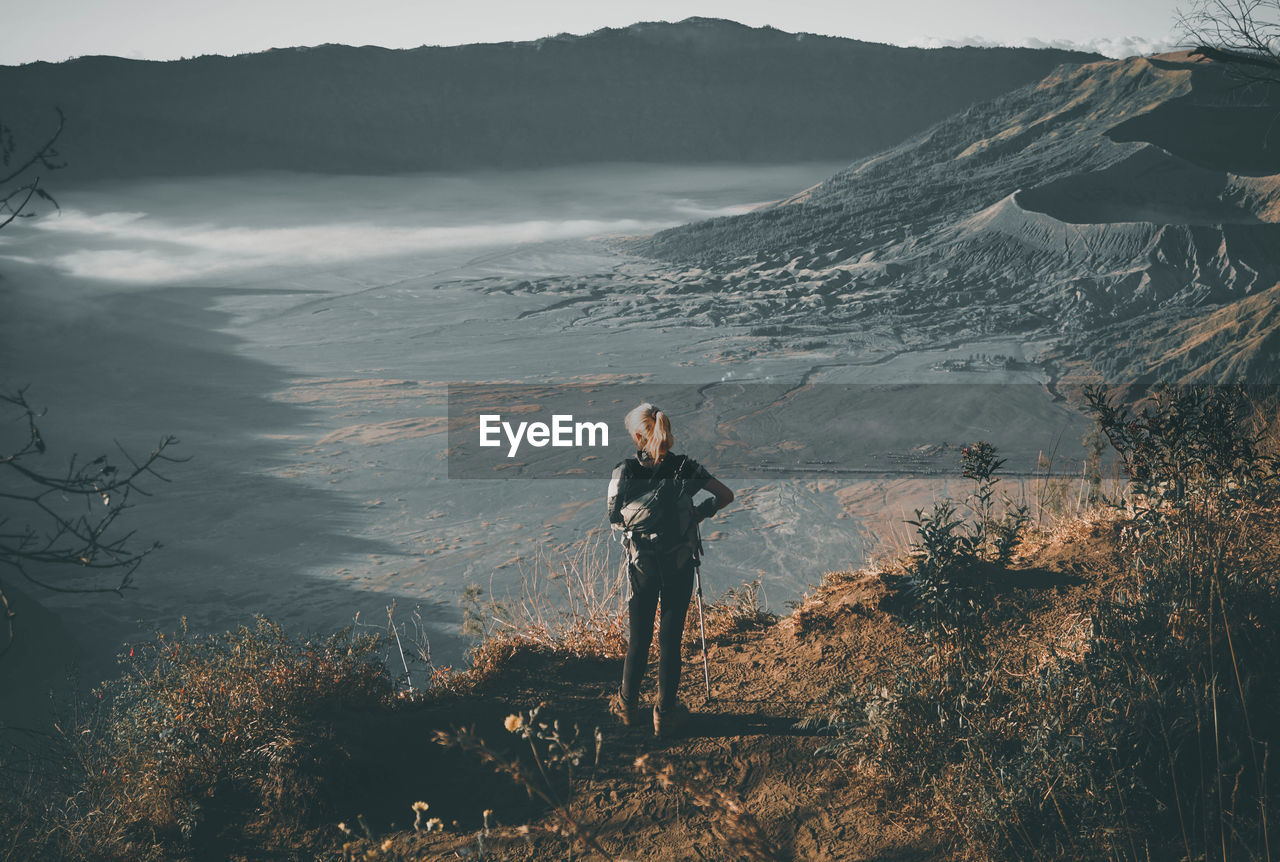 Rear view of woman standing at mt bromo