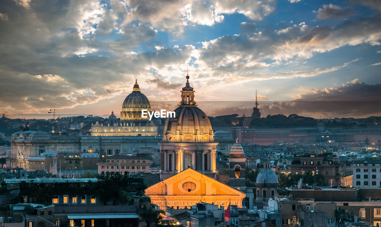 View of buildings in city against sky during sunset