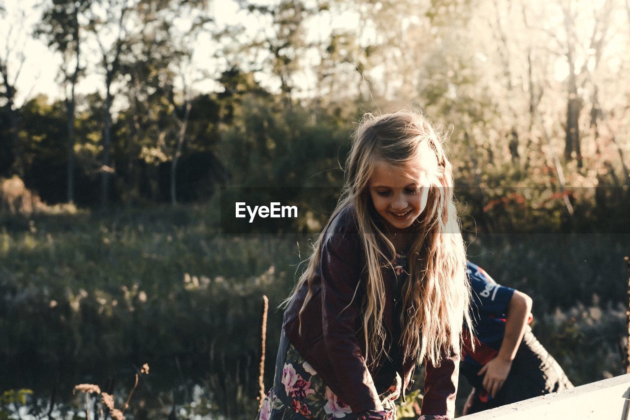 Smiling girl playing outdoors during sunset