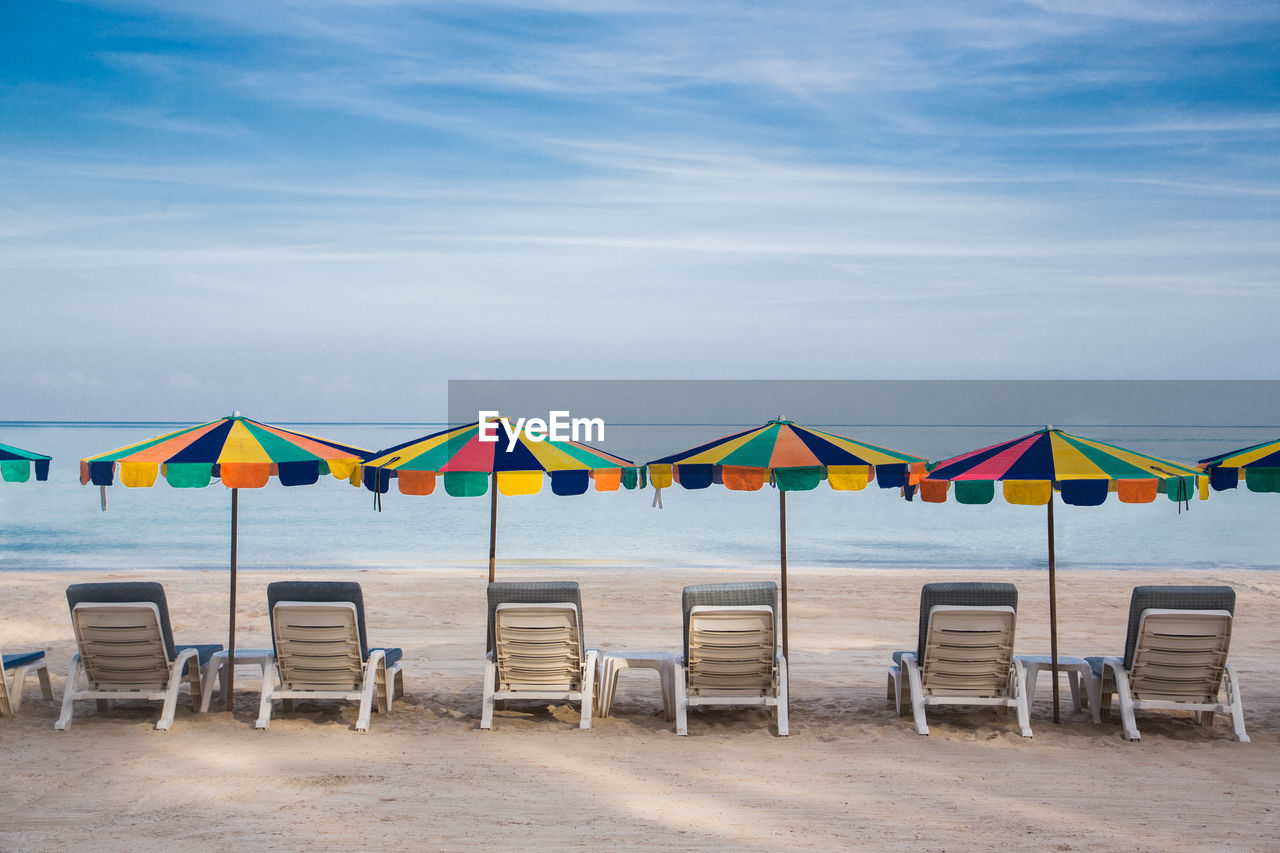 Colorful umbrella at the beach with blue sky.