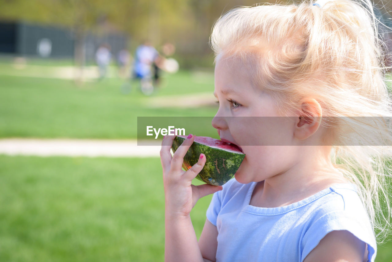 Close-up of girl eating watermelon