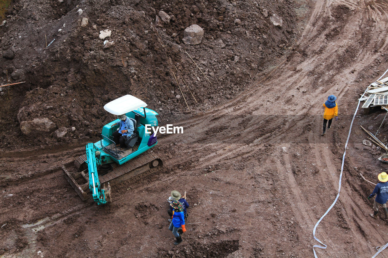 soil, high angle view, day, land, nature, men, outdoors, extreme sports, working, environment, transportation, group of people, dirt, full length, occupation