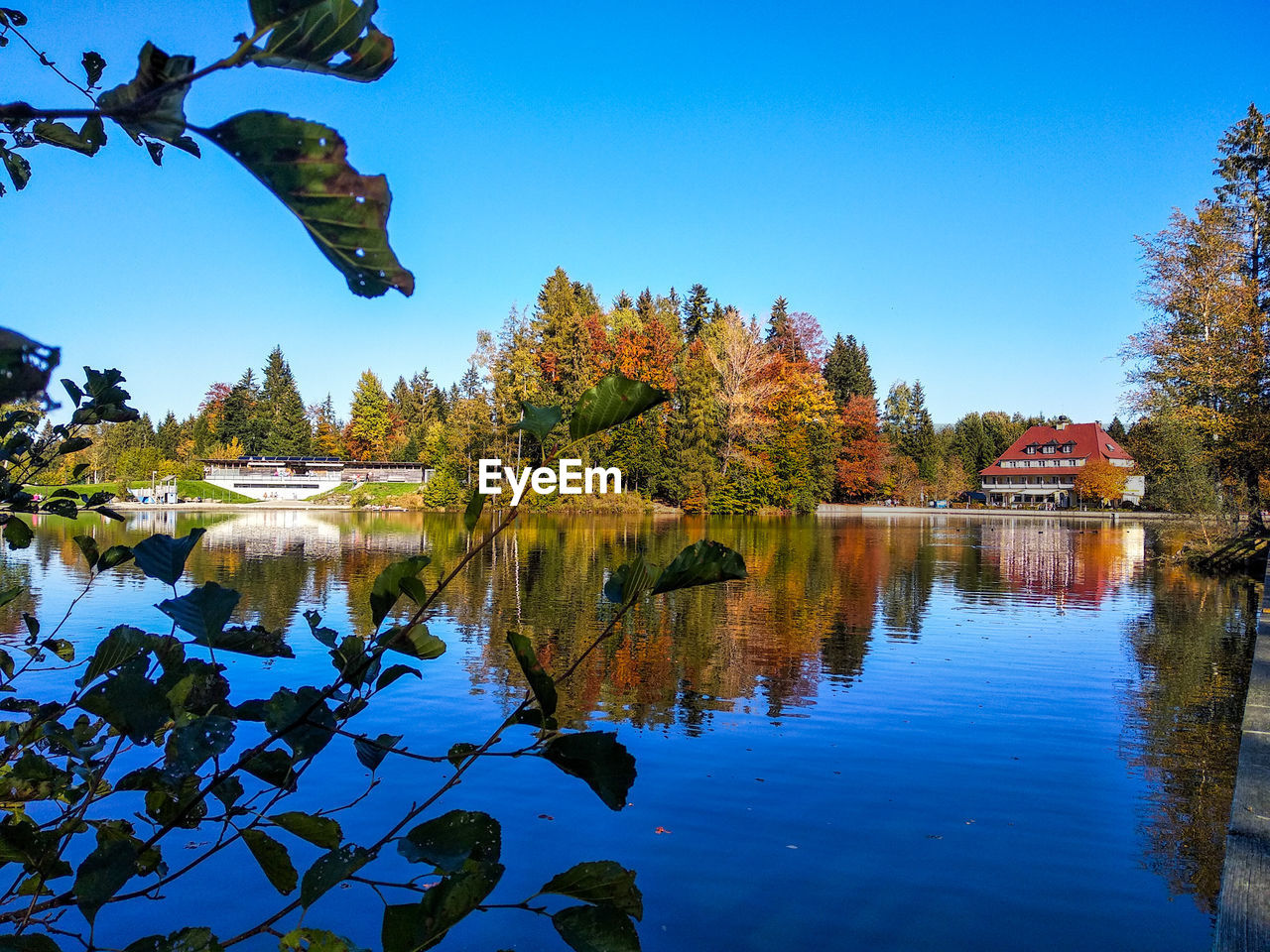 Scenic view of lake against clear blue sky