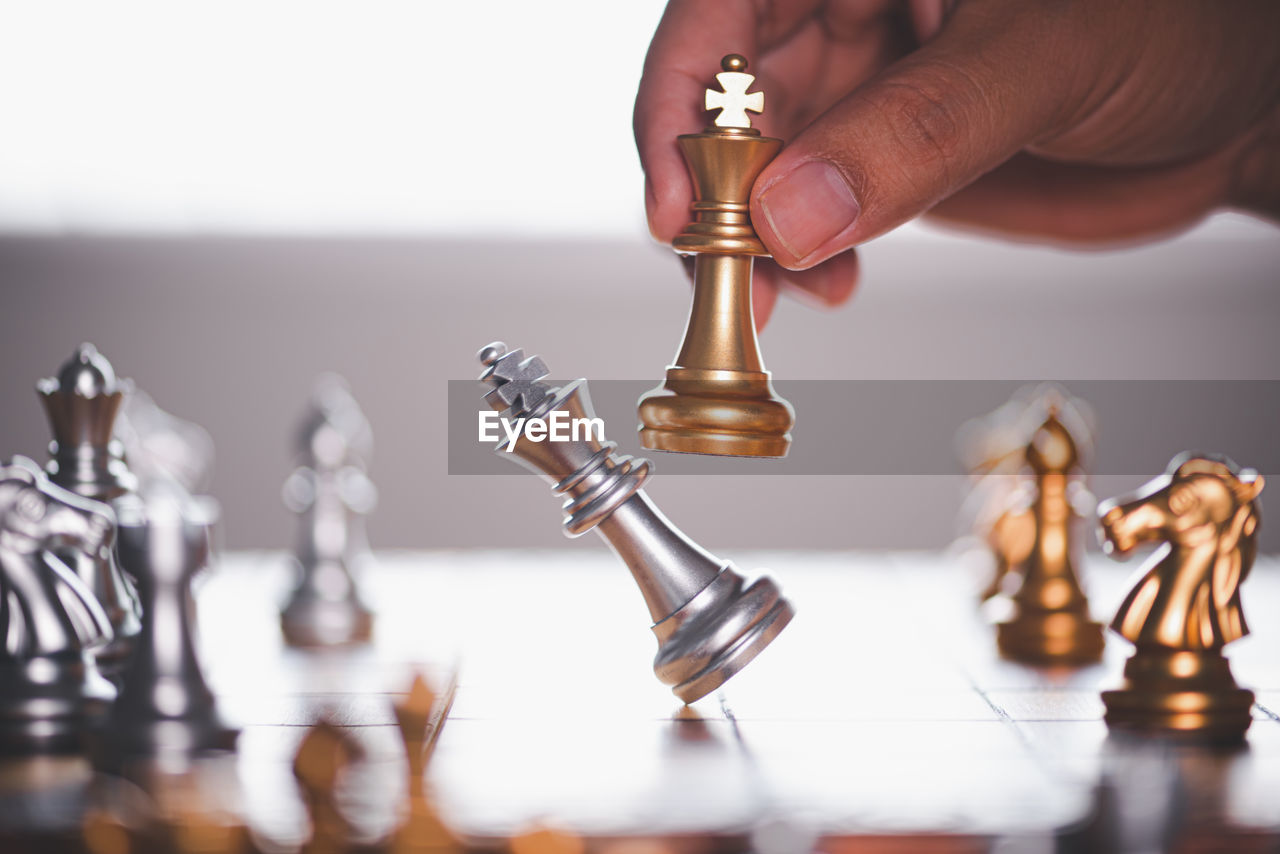 LOW ANGLE VIEW OF MAN PLAYING WITH CHESS