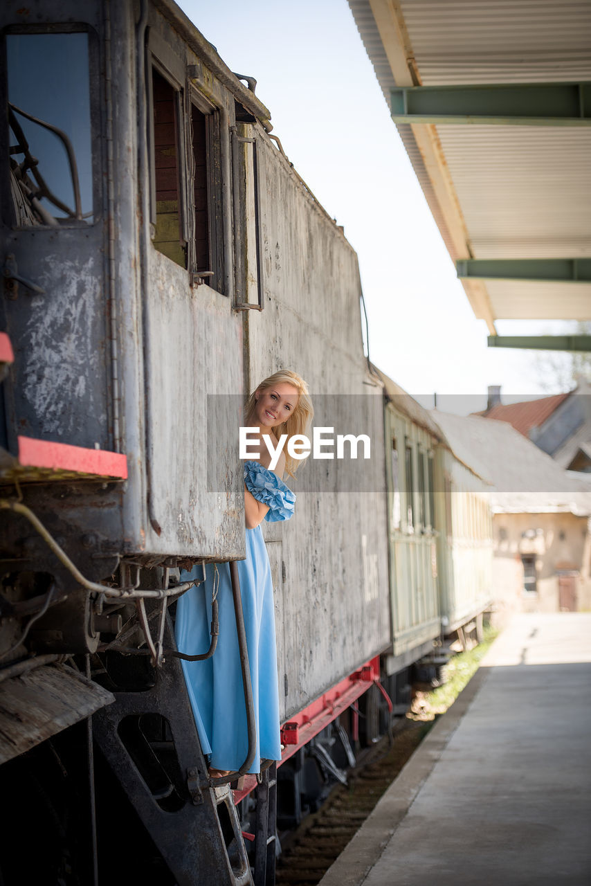 Happy young woman in old train